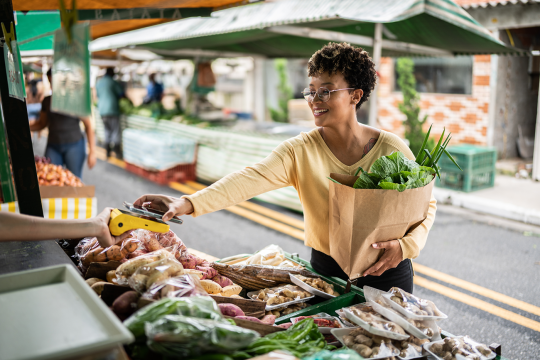 Lady paying for grocery using her mobile phone