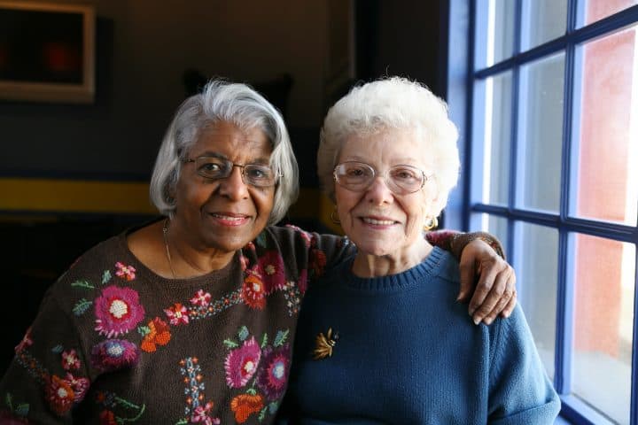 Two senior women with hand on shoulder
